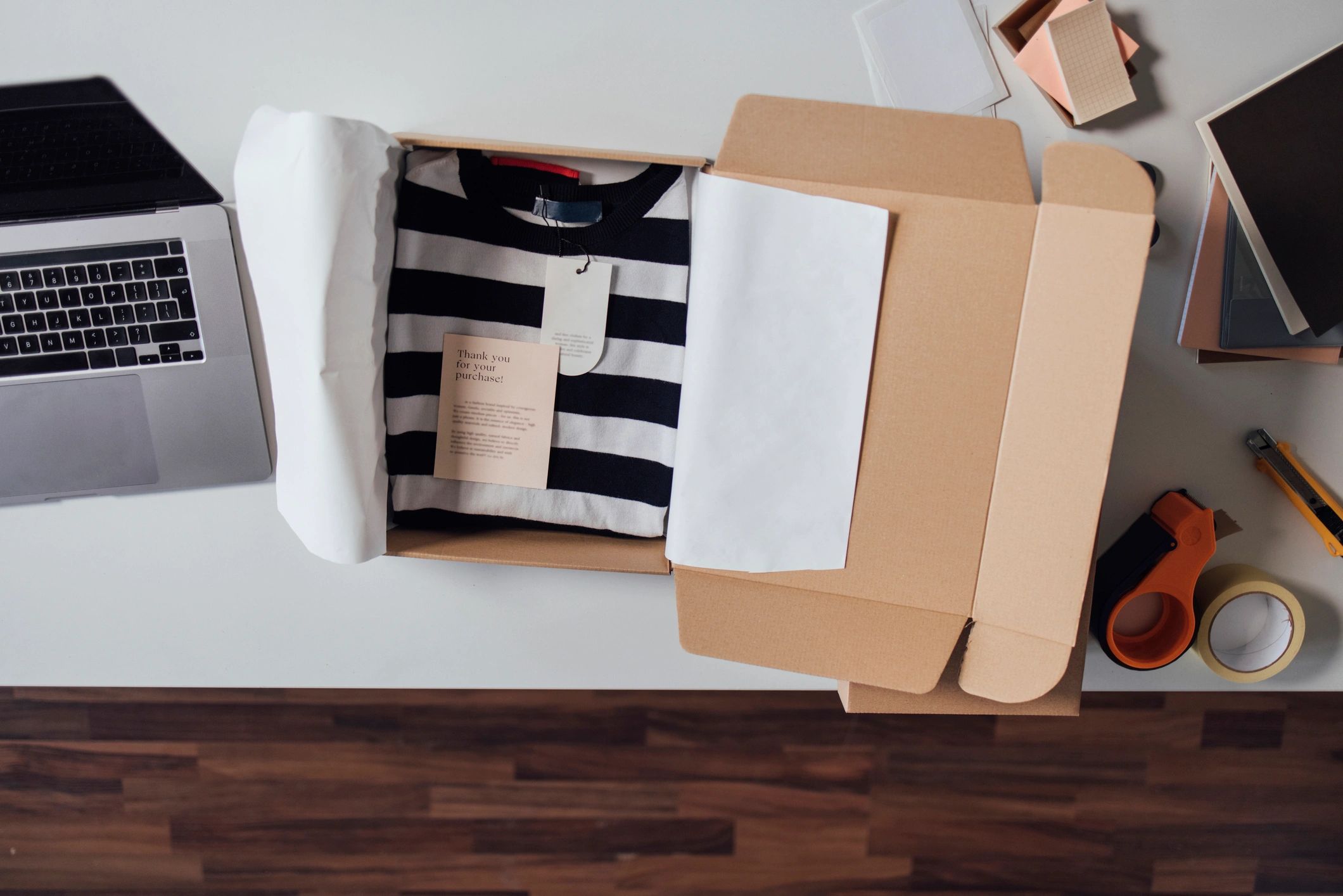 Open box with clothing prepared for shipping