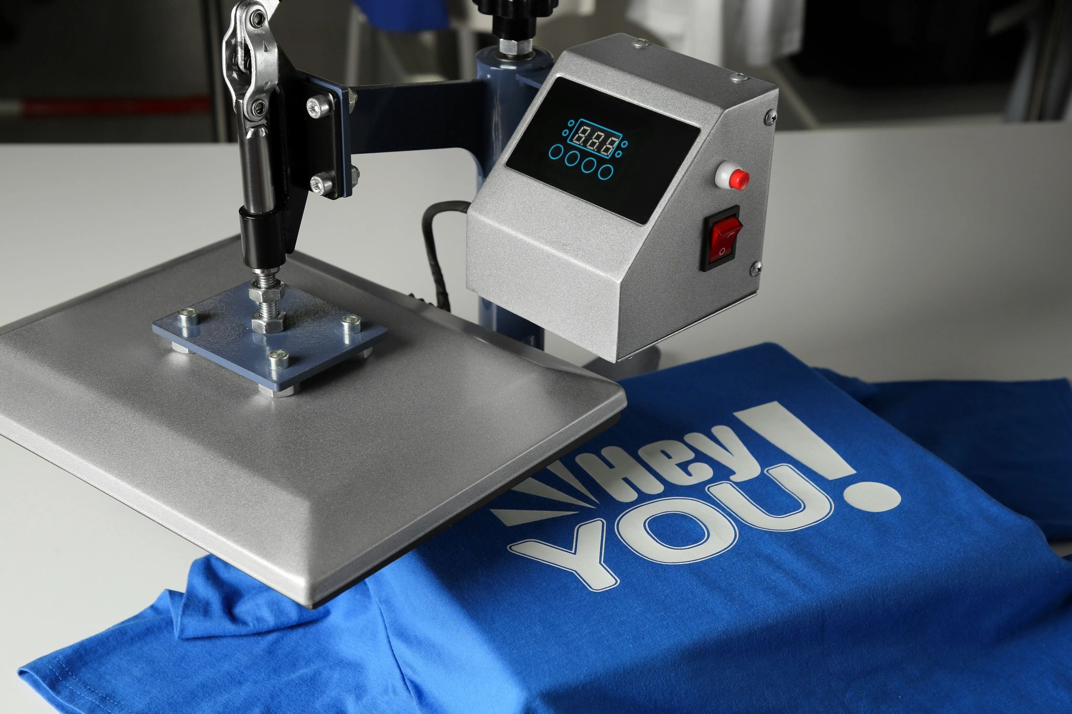 Heat press printing a logo on a blue t-shirt